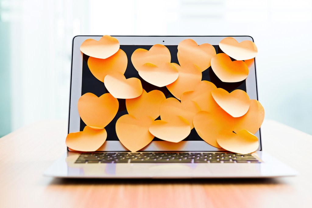 Heart shaped sticky notes on laptop